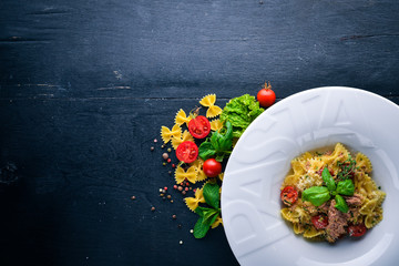 Pasta with tomatoes and basil. Plate with the word 