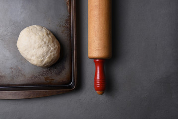 A ball of raw bread dough on a baking sheet