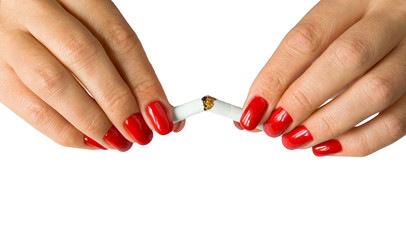 Beautiful female fingers break a cigarette.
