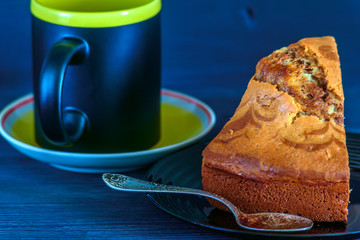 coffee and a piece of cake for breakfast on a black plate 