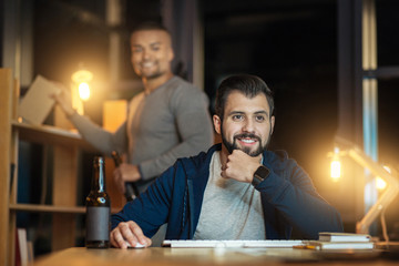 Positive delighted IT man doing his job