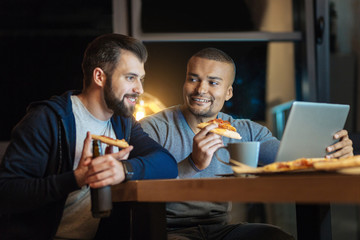 Delighted bearded man sitting in semi position
