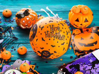 Halloween decoration symbols on dark rustic wooden background. Wishing happy holiday with orange...
