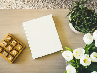 Blank Book cover on table with floral plant Home decoration