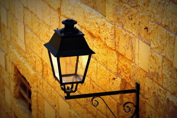 Old iron street lantern on a wall