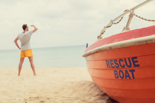 Rescue Boat And Lifeguard Watching At The Distance. Optical Focus In On The Boat.