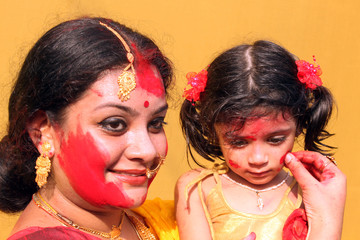 Beautiful bengali woman is playing Sindur with her daughter, Calcutta West Bengal