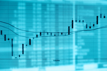 Financial stock market graph and laptop trade monitor double exposure.