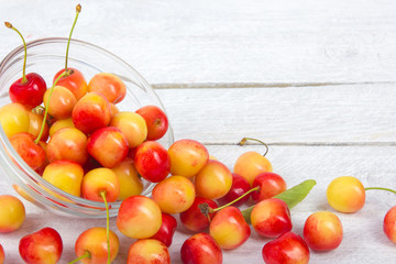 Cherry. Cherries in bowl. Fresh yellow cherry. Cherry on white wooden background. healthy food concept