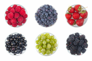Berries on Isolated white background, bowl of Cherry, currant, blueberries, gooseberries, raspberries, blackberries, strawberries.