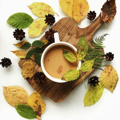 flat lay food still-life of dry autumn leafs and cup of soup