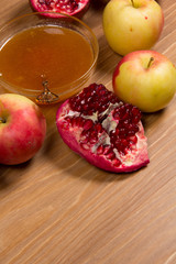 Pieces ripe pomegranate, honey and apple