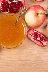Pieces ripe pomegranate, honey and apple