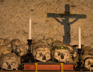 Painted skulls with names, candles and cross