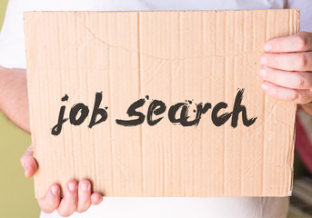 job search on cardboard in hands man