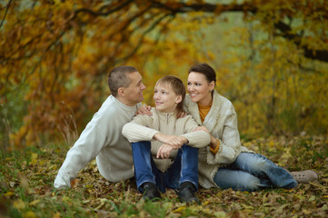 Naklejka na ściany i meble Happy family in the autumn park