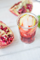 Top view of pomegranate lemonade with lime and ice