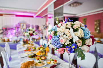 Floral compositions made of different flowers, decorated for the wedding celebration in the restaurant exclusively.