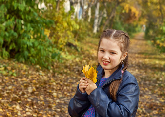 little girl having fun on beautiful autumn