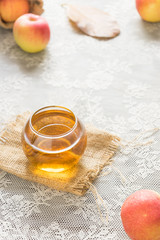 hot apple juice in glass on white fabric. autumn food concept