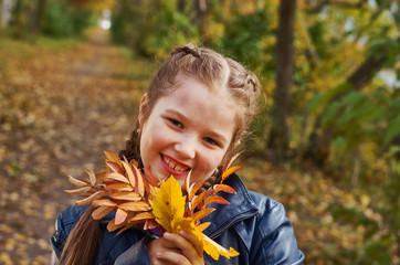 little girl having fun on beautiful autumn