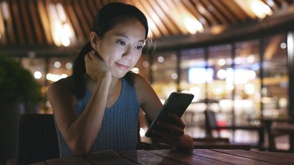 Woman uses smart phone for online