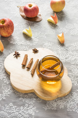 hot apple juice in glass with cinnamon. autumn food concept
