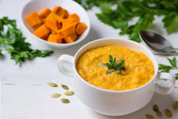 Vegetarian pumpkin soup in a bowl on the table.