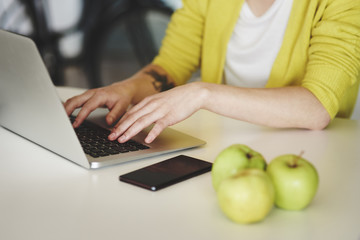 Unrecognizable person typing on laptop keyboard