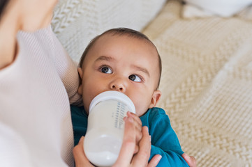 Toddler drinking from milk bottle