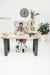 businessman in soccer shoes with ball