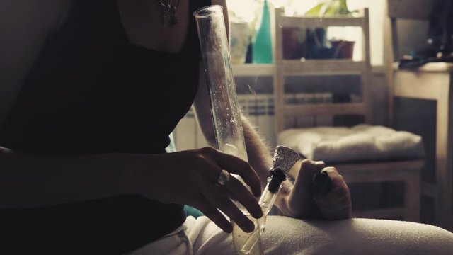 Smoking medical marijuana through the bong close-up .Medical marijuana, weed, pot  and legalization around the world