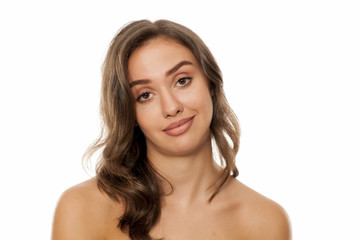 Fototapeta premium Portrait of beautiful young satisfied woman on white background