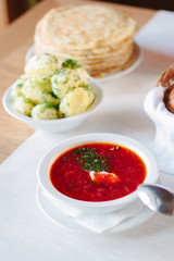 Beautiful russian national soup - borscht at white plate.