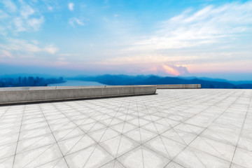 empty marble floor with modern city near long river