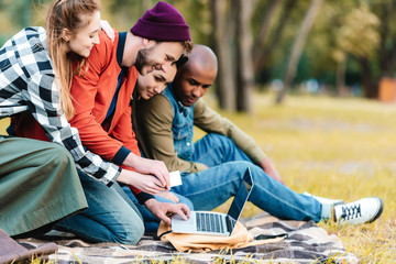 multicultural friends with laptop