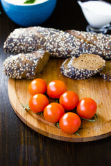 Hip of cherry tomatoes over the wooden board.