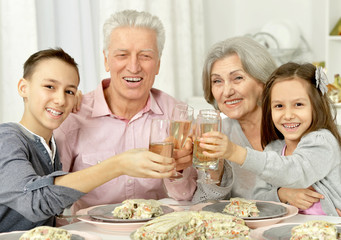 Grandparents and grandsons clanging glasses