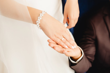 Marry me. Bride and groom's hands with wedding rings