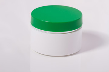 Close up of beauty blank cream container or jar isolated on white background . Mock up and copy space. Selective focus