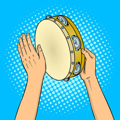 Hands with tambourine pop art vector illustration