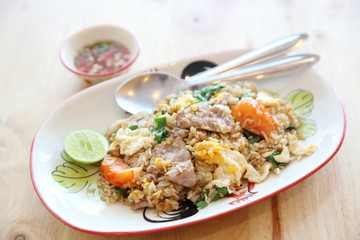 Fototapeta na wymiar Pork fried rice with lime on wood background , Thai food