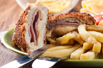 Cutlet Cordon Bleu with pork loin served with French fries and salad