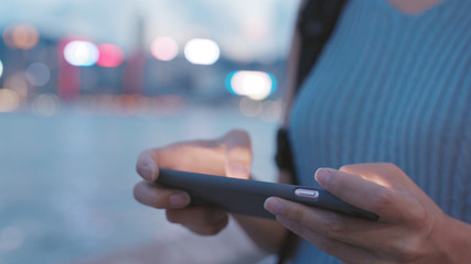 Playing game on cellphone in the evening