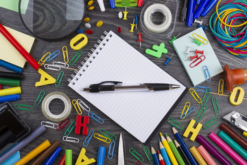 Back to school. Set of school objects for modern education: pens, scissors, pensils and other multicolored accessories on wooden desk