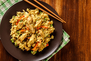 Fried rice nasi goreng with chicken and vegetables on a plate