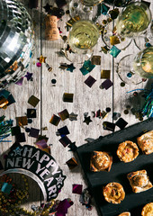 New Year: Overhead View Of Table With Appetizers And NYE Crown