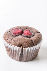 Chocolate cup cake muffin with fresh raspberry isolated on the white background with copy space