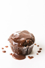 Chocolate cup cake muffin with melting topping chocolate cream on the white marble background