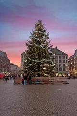 Poster Christmas in Amsterdam on the Damsquare in the Netherlands at sunset © Nataraj